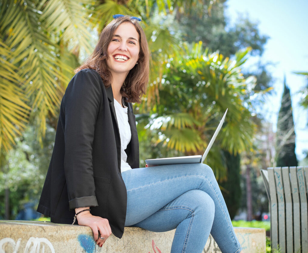 Young U.S. Expat Working Abroad outside with Palm Trees